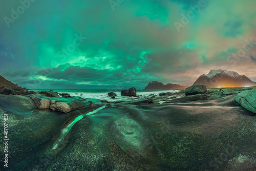 Scenic landscape of aurora over rocky seashore in Norway photo