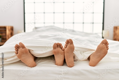 Two hispanic men couple lying on bed at bedroom photo