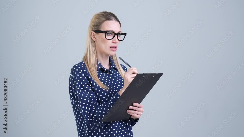 Minded lady consultant write to do list isolated grey color background Minded lady consultant write to do list isolated grey color background
