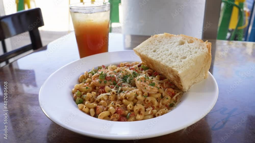 Cajun seafood crawfish macaroni pasta dish, cafe table top, slider 4K Cajun seafood crawfish macaroni pasta dish, cafe table top, slider 4K