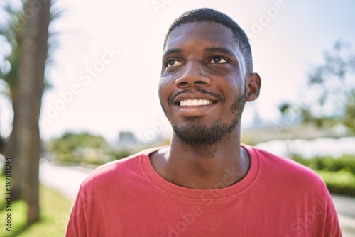 Young african man smiling confident at park © Krakenimages.com