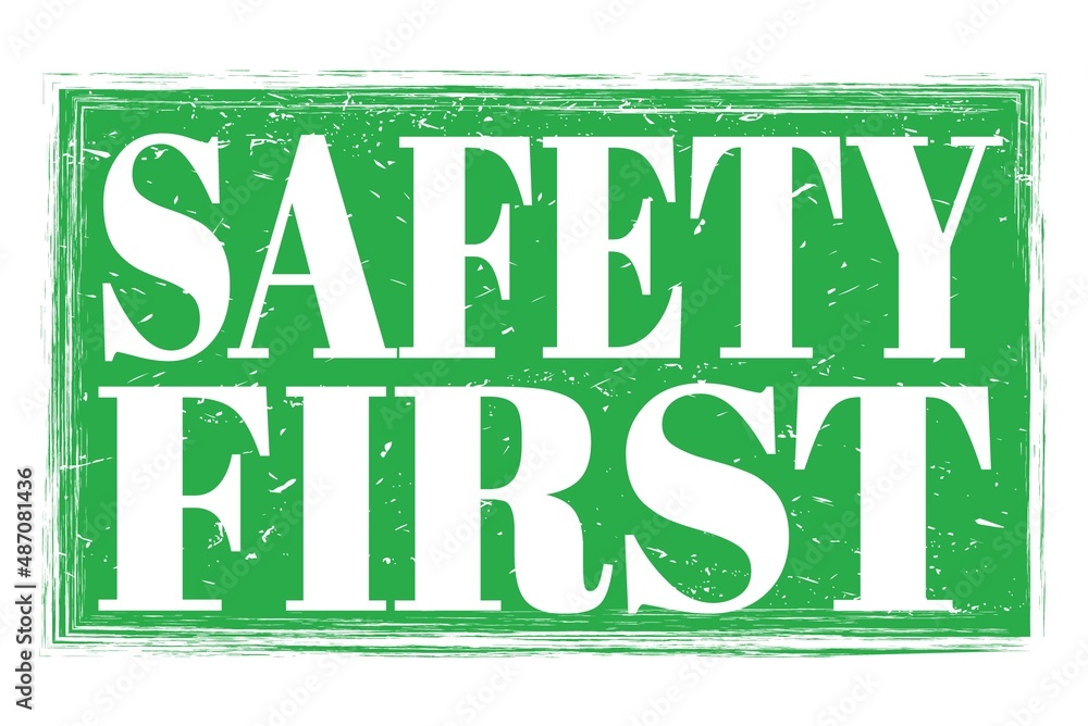 SAFETY FIRST, words on green grungy stamp sign SAFETY FIRST, words on green grungy stamp sign