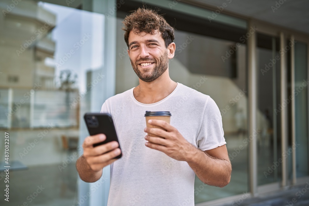 Young hispanic man using smartphone drinking coffee at street Young hispanic man using smartphone drinking coffee at street