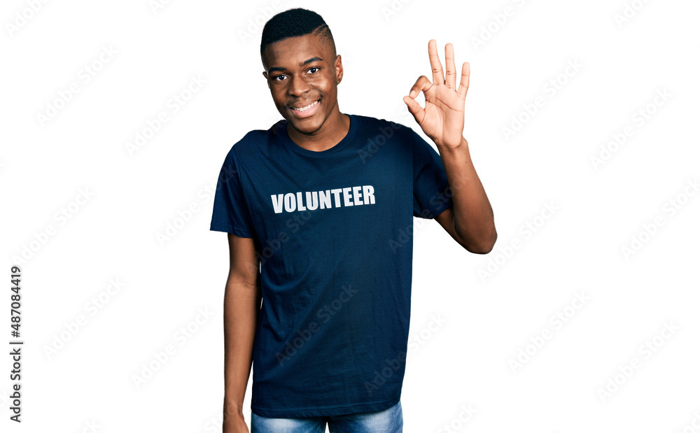 Young african american man wearing volunteer t shirt smiling positive doing ok sign with hand and fingers. successful expression. Young african american man wearing volunteer t shirt smiling positive doing ok sign with hand and fingers. successful expression.