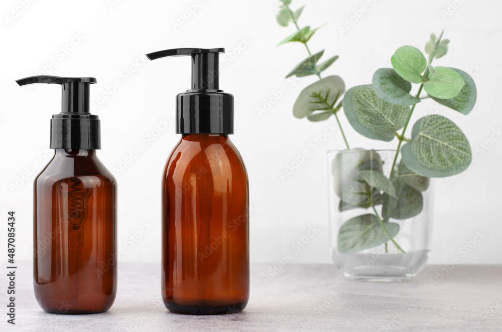 Cosmetics branding mockup. Cosmetic bottles with a dispenser. Natural organic cosmetics for personal hygiene. Cosmetics branding mockup. Cosmetic bottles with a dispenser. Natural organic cosmetics for personal hygiene.