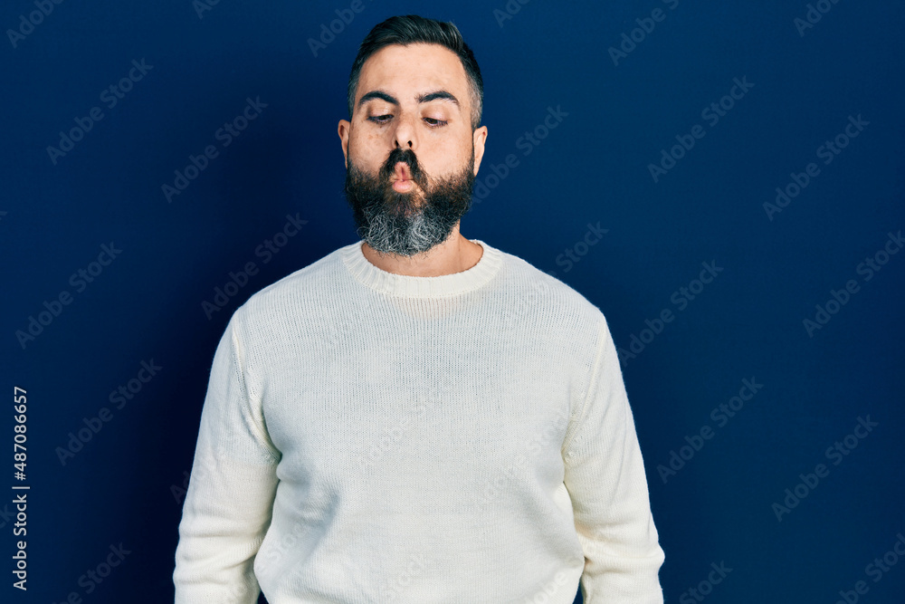 Obraz premium Young hispanic man wearing casual clothes making fish face with lips, crazy and comical gesture. funny expression.