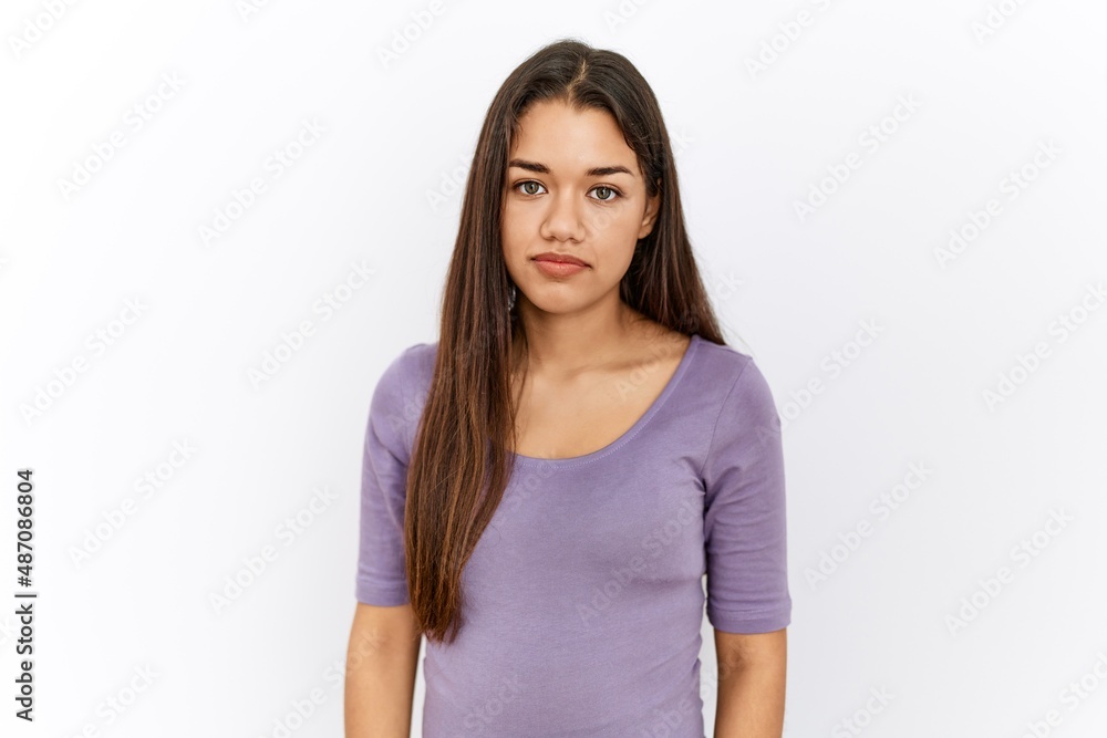 Young brunette woman standing by isolated background skeptic and nervous, frowning upset because of problem. negative person. Young brunette woman standing by isolated background skeptic and nervous, frowning upset because of problem. negative person.