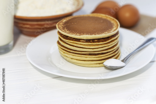 Pancakes with ingredients: flour, eggs, milk, soda