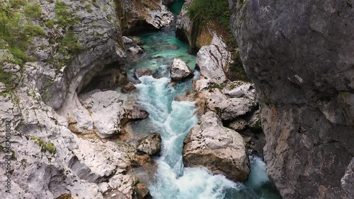 Aerial View Above The Surface Of A Mountain River Soca , stream flowing through rocky canyon. River stones with flowing water, clean water flowing in a mountain river