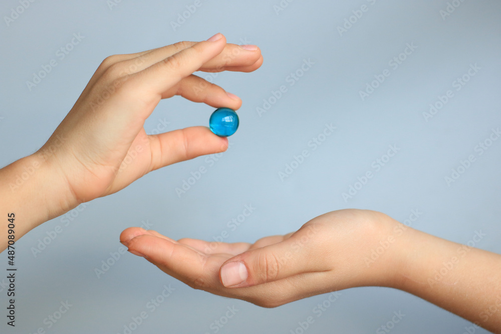 A child shares a precious pearl with a friend. Conceptual photo of reconciliation and friendship