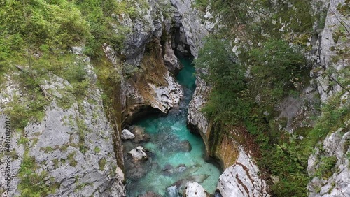 Aerial View Above The Surface Of A Mountain River Soca , stream flowing through rocky canyon. River stones with flowing water, clean water flowing in a mountain river