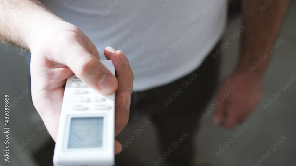 4k. Man hand using air conditioner remote control close-up. 4k. Man hand using air conditioner remote control close-up.
