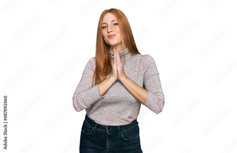 Young irish woman wearing casual clothes praying with hands together asking for forgiveness smiling confident. Young irish woman wearing casual clothes praying with hands together asking for forgiveness smiling confident.