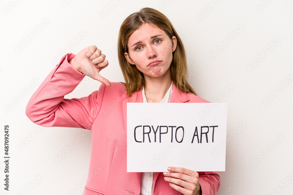 Young English business woman holding a crypto money placard isolated on white background showing a dislike gesture, thumbs down. Disagreement concept. Young English business woman holding a crypto money placard isolated on white background showing a dislike gesture, thumbs down. Disagreement concept.