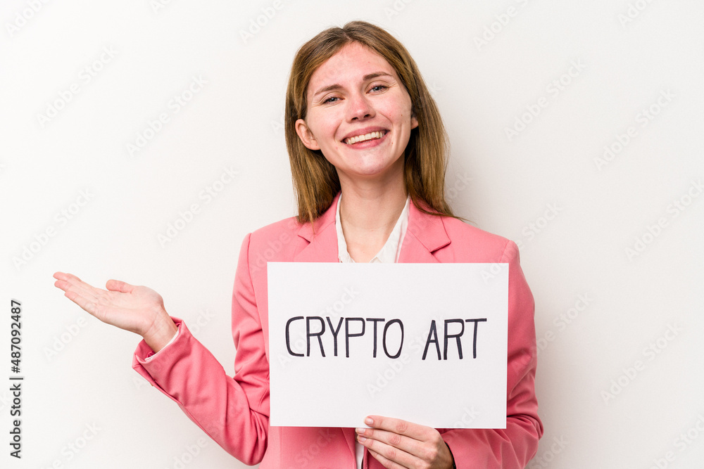 Young English business woman holding a crypto money placard isolated on white background showing a copy space on a palm and holding another hand on waist. Young English business woman holding a crypto money placard isolated on white background showing a copy space on a palm and holding another hand on waist.