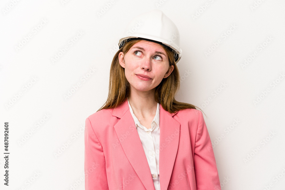 Young architect English woman with helmet isolated on white background dreaming of achieving goals and purposes Young architect English woman with helmet isolated on white background dreaming of achieving goals and purposes