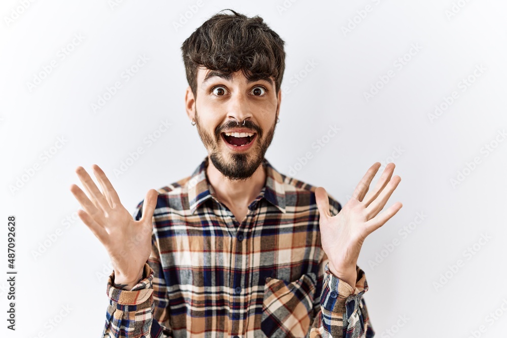 Hispanic man with beard standing over isolated background celebrating crazy and amazed for success with arms raised and open eyes screaming excited. winner concept Hispanic man with beard standing over isolated background celebrating crazy and amazed for success with arms raised and open eyes screaming excited. winner concept