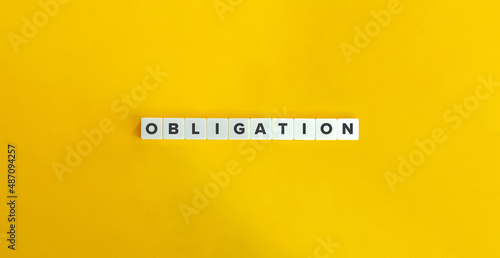 Obligation word on letter tiles on bright orange background. Minimal aesthetics.