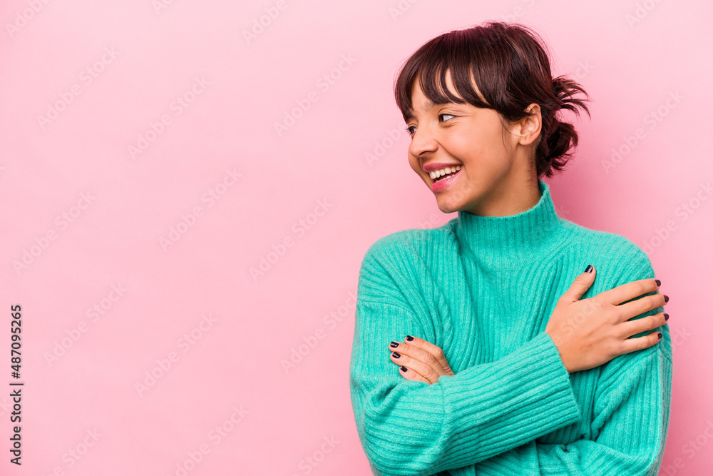Fototapeta premium Young hispanic woman isolated on pink background smiling confident with crossed arms.