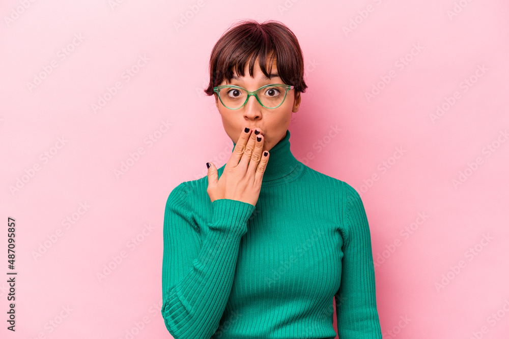 Young hispanic woman isolated on pink background shocked, covering mouth with hands, anxious to discover something new. Young hispanic woman isolated on pink background shocked, covering mouth with hands, anxious to discover something new.