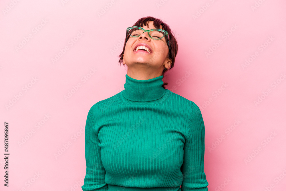 Young hispanic woman isolated on pink background relaxed and happy laughing, neck stretched showing teeth. Young hispanic woman isolated on pink background relaxed and happy laughing, neck stretched showing teeth.