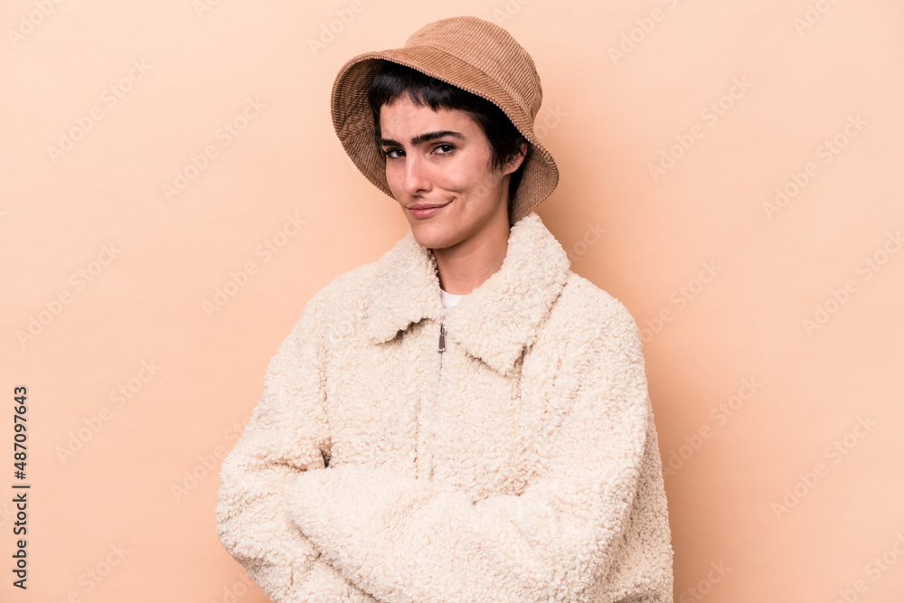 Young caucasian woman isolated on beige background unhappy looking in camera with sarcastic expression. Young caucasian woman isolated on beige background unhappy looking in camera with sarcastic expression.