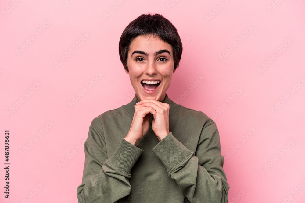 Young caucasian woman isolated on pink background praying for luck, amazed and opening mouth looking to front. Young caucasian woman isolated on pink background praying for luck, amazed and opening mouth looking to front.