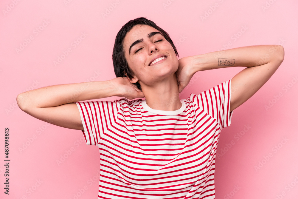 Young caucasian woman isolated on pink background feeling confident, with hands behind the head. Young caucasian woman isolated on pink background feeling confident, with hands behind the head.