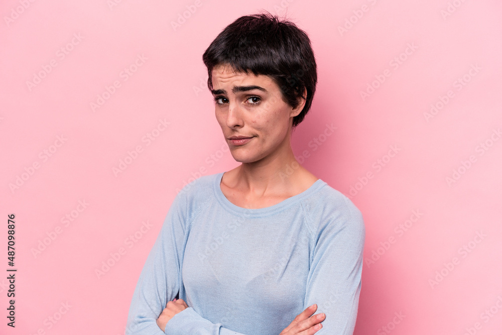 Obraz premium Young caucasian woman isolated on pink background unhappy looking in camera with sarcastic expression.