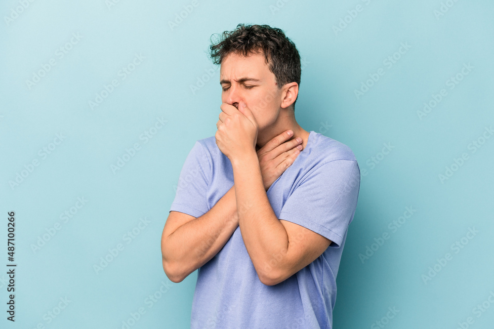 Young caucasian man isolated on blue background suffers pain in throat due a virus or infection. Young caucasian man isolated on blue background suffers pain in throat due a virus or infection.
