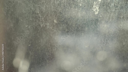 Dirty window. Glass stained with dust, dirt and drops of rain and snow.