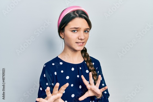 Young brunette girl wearing elegant look disgusted expression, displeased and fearful doing disgust face because aversion reaction. with hands raised