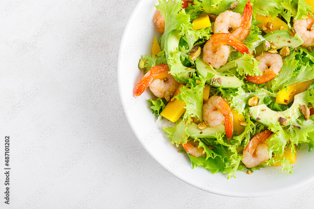 Grilled shrimp salad with avocado, mango, lettuce and pistachios, dressed with lime. Healthy food. Ketogenic diet. Top view. Grilled shrimp salad with avocado, mango, lettuce and pistachios, dressed with lime. Healthy food. Ketogenic diet. Top view.