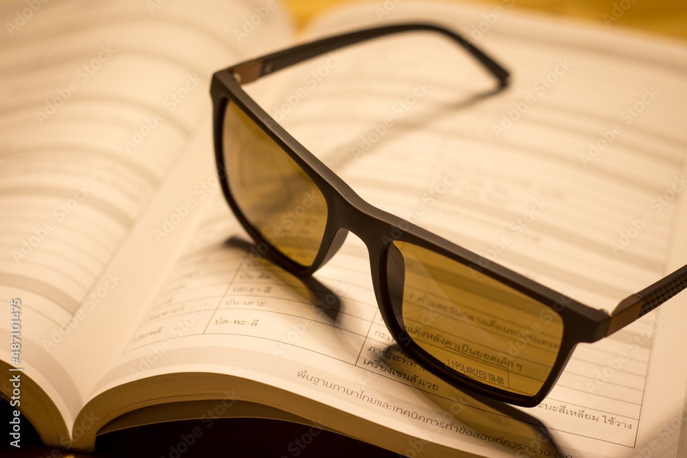 Glasses and books placed on the table in the living room. educational concepts and knowledge in the evening
Glasses and books placed on the table in the living room. educational concepts and knowledge in the evening