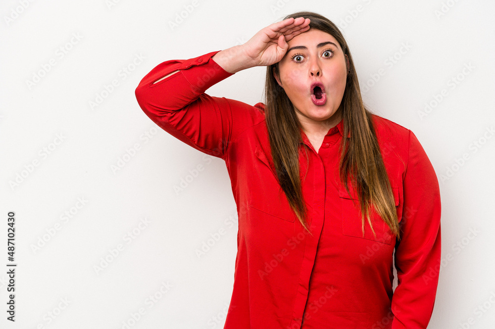 Young caucasian overweight woman isolated on white background shouts loud, keeps eyes opened and hands tense. Young caucasian overweight woman isolated on white background shouts loud, keeps eyes opened and hands tense.