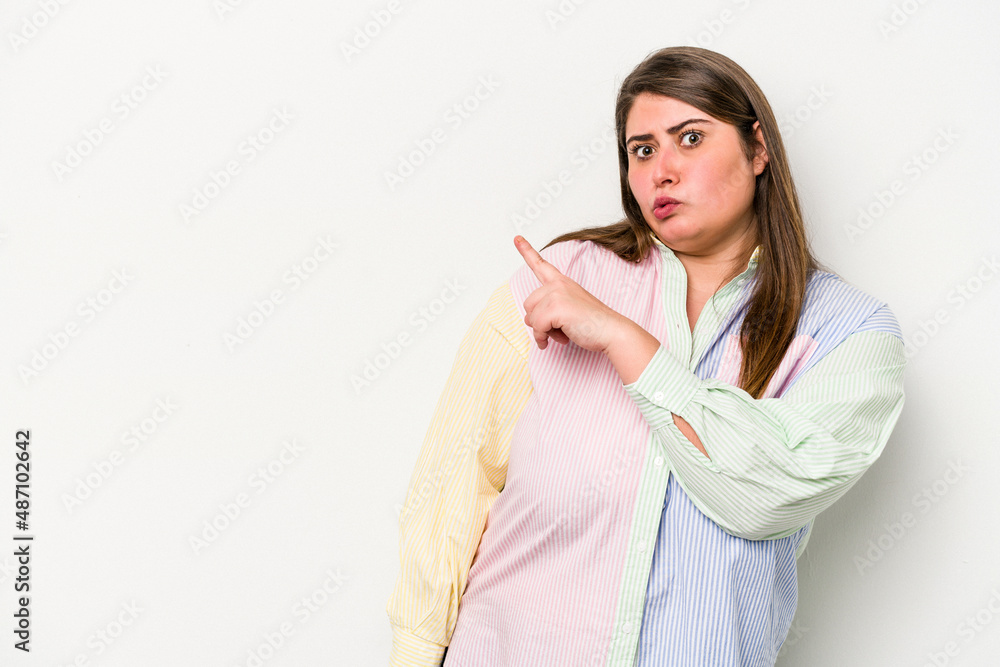 Young caucasian overweight woman isolated on white background smiling and pointing aside, showing something at blank space. Young caucasian overweight woman isolated on white background smiling and pointing aside, showing something at blank space.