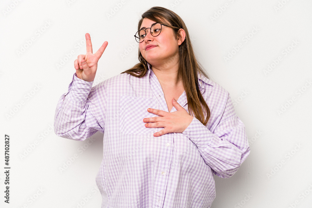 Young caucasian overweight woman isolated on white background taking an oath, putting hand on chest. Young caucasian overweight woman isolated on white background taking an oath, putting hand on chest.