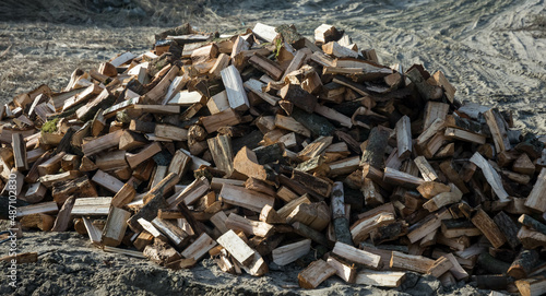 Pile of dry chopped firewood outdoors