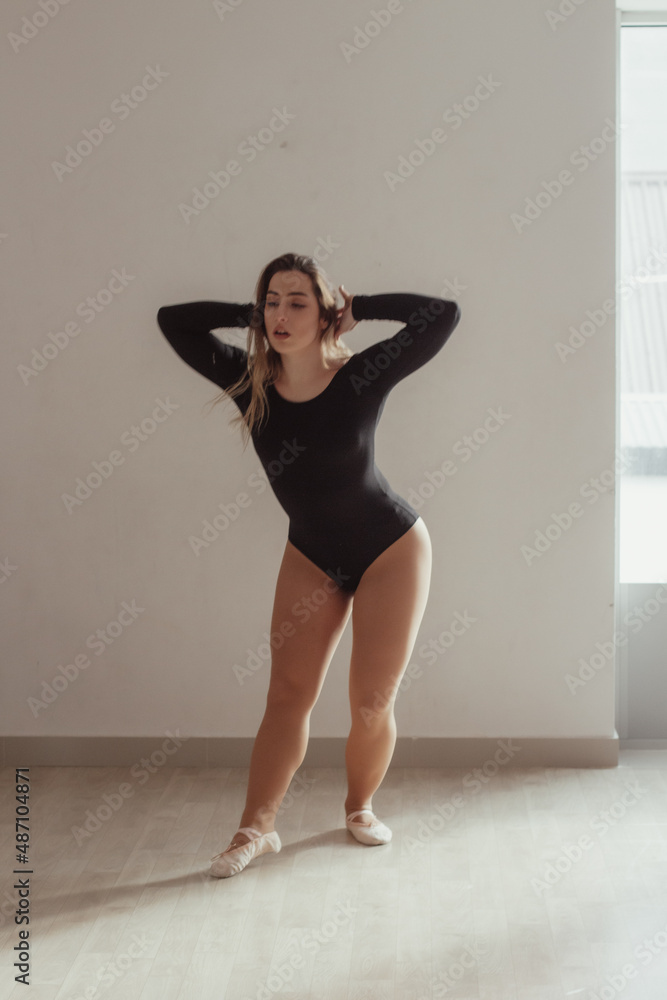 A woman standing in a dance pose in a dance studio, dressed in a dance outfit. A woman standing in a dance pose in a dance studio, dressed in a dance outfit.