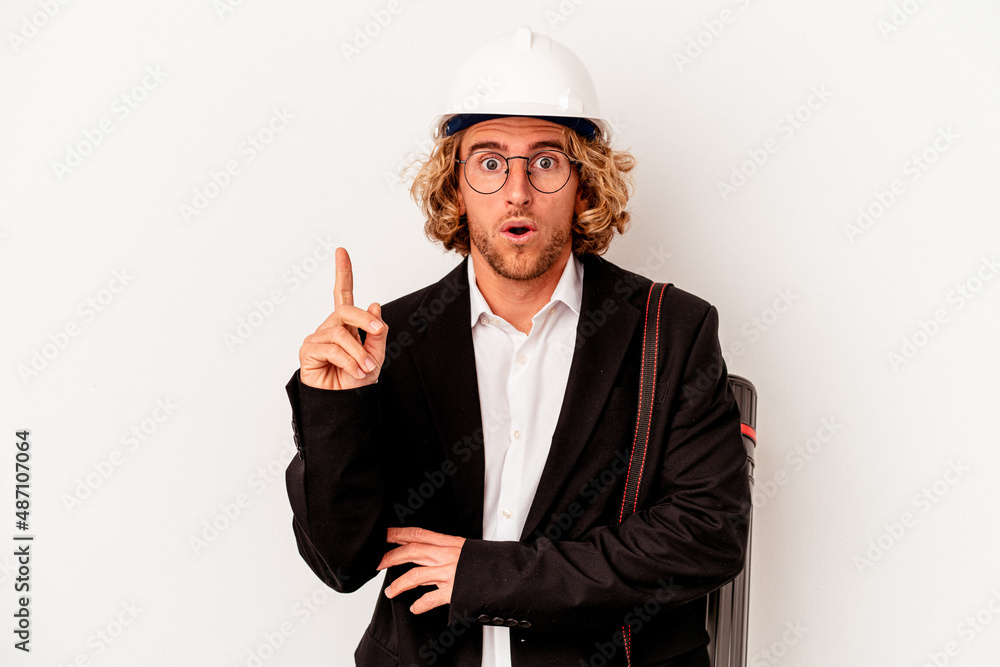Young architect caucasian man with helmet isolated on white background having some great idea, concept of creativity.