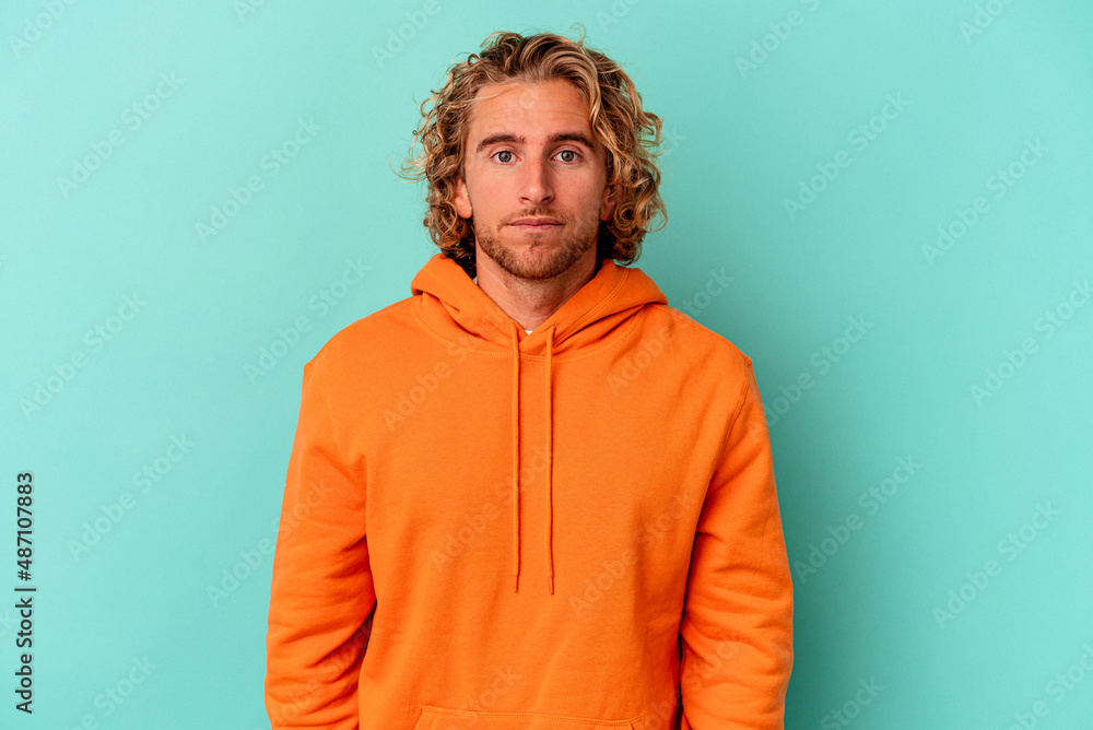 Young caucasian man isolated on blue background sad, serious face, feeling miserable and displeased. Young caucasian man isolated on blue background sad, serious face, feeling miserable and displeased.