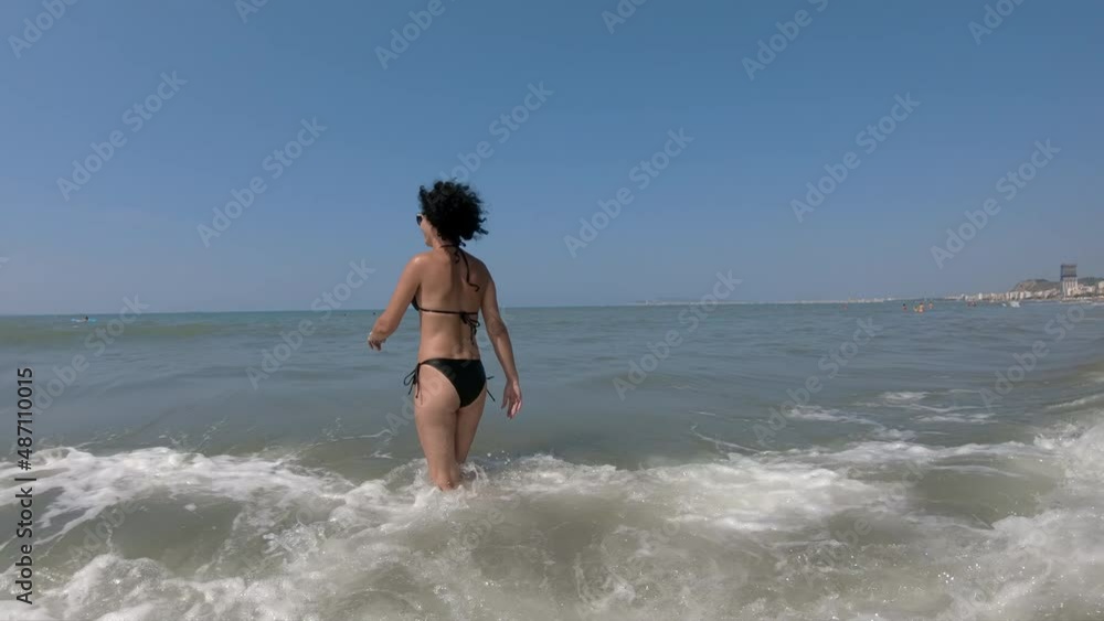 Women jumping and splashing in sea waves, slow motion Women jumping and splashing in sea waves, slow motion