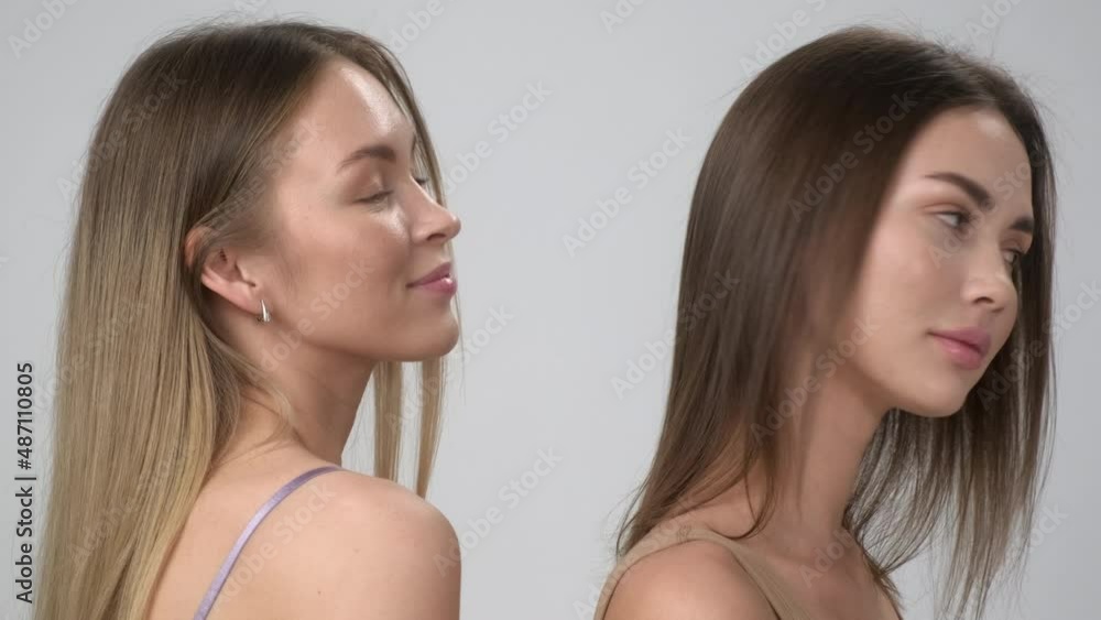 Two young multiracial women, asian and a caucasian girls, pose together on a white background. Beautiful bodies and perfect skin, cotton underwear. Two young multiracial women, asian and a caucasian girls, pose together on a white background. Beautiful bodies and perfect skin, cotton underwear.