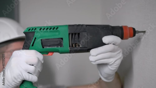 Wallpaper Mural Construction puncher. Professional green electric perforator drill. Torontodigital.ca