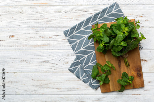 Fresh mint on Cutting board table, top view. Flat lay Space for text