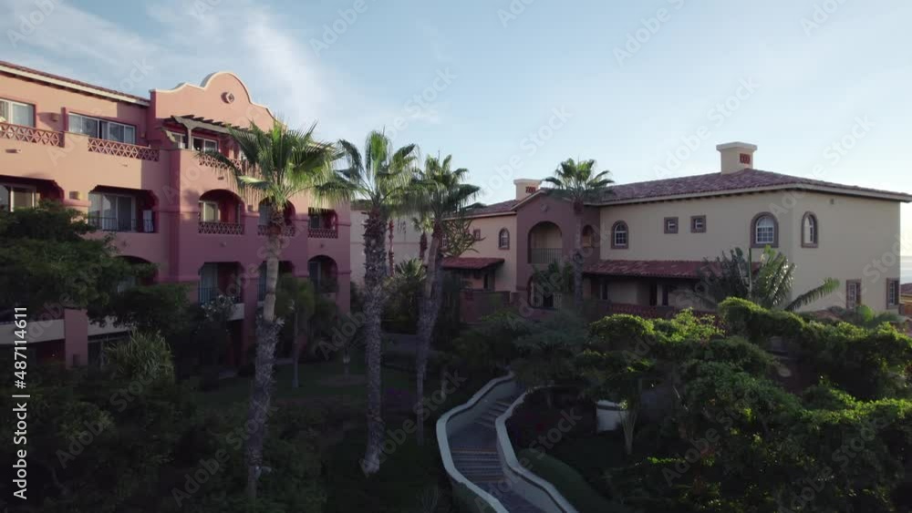 Overlooking an idyllic community along a tropical coastline on a beautiful morning - ascending aerial view Overlooking an idyllic community along a tropical coastline on a beautiful morning - ascending aerial view