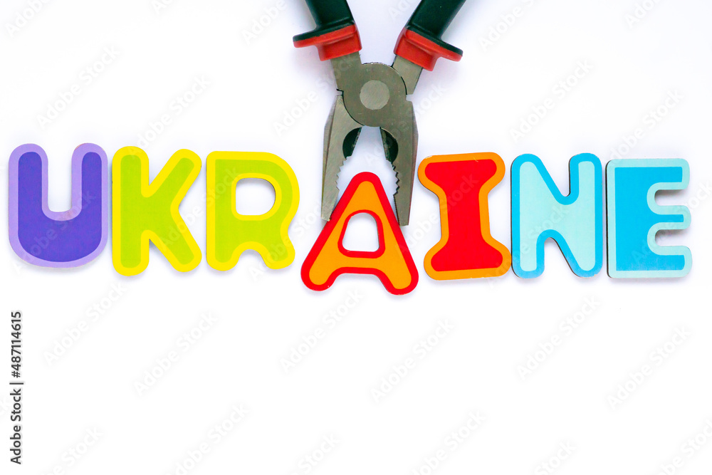 Ukraine text made of toy letters falling apart - a concept of Russia attack on Ukraine and World War 3 thread in Europe.