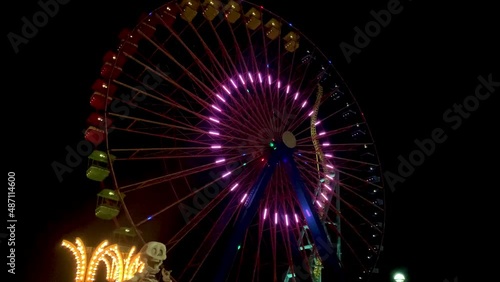 A colorful giant ferris wheel with colorful lights at night in cedar point photo