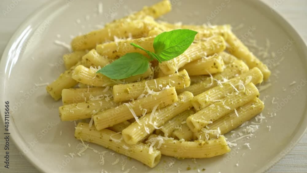 pesto rigatoni pasta with parmesan cheese - Italian food and vegetarian food style pesto rigatoni pasta with parmesan cheese - Italian food and vegetarian food style