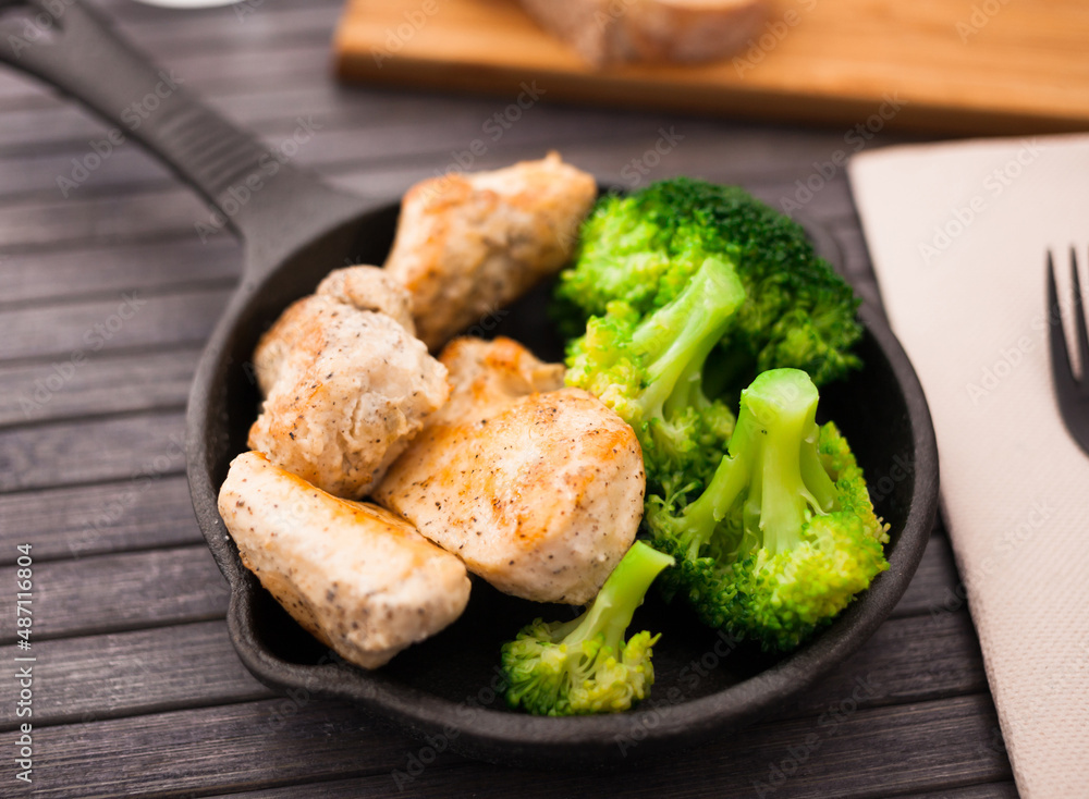 chicken breast with broccoli in small cast iron skillet